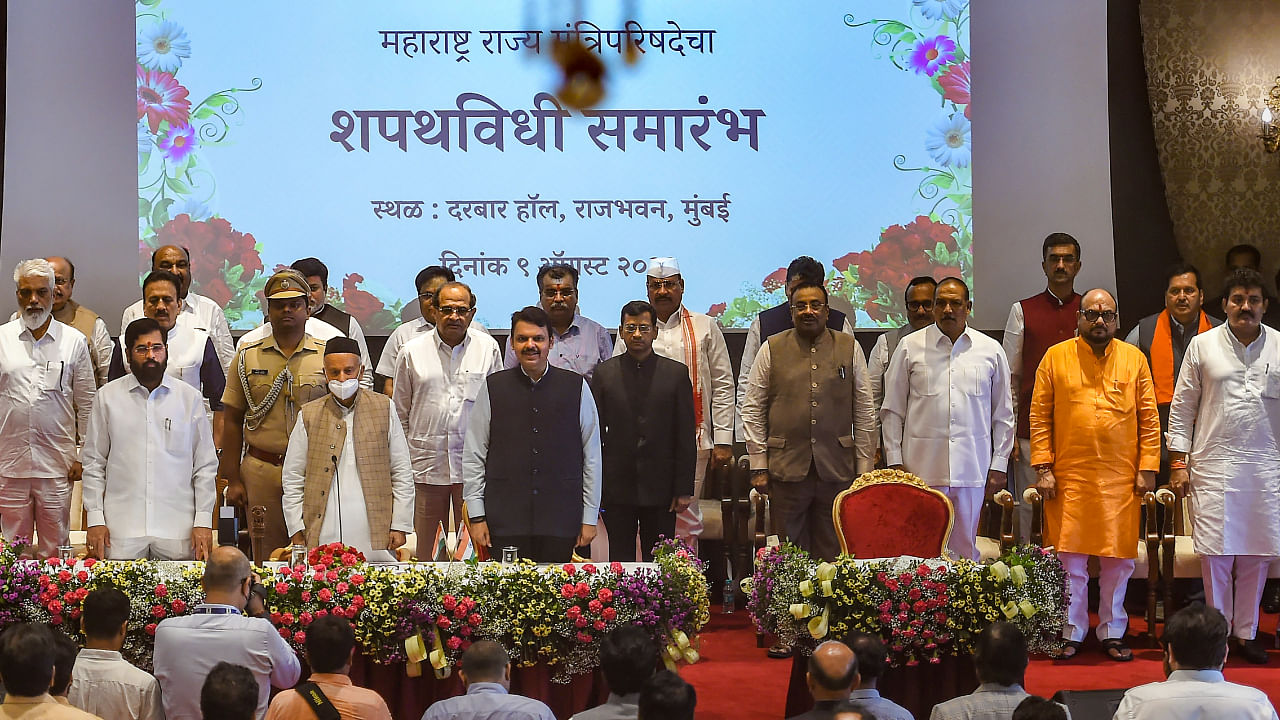 Maharashtra Governor Bhagat Singh Koshyari, Chief Minister Eknath Shinde and Dy CM Devendra Fadnavis with newly sworn-in ministers, at a ceremony at Raj Bhavan in Mumbai, Tuesday, Aug. 9, 2022. Credit: PTI Photo