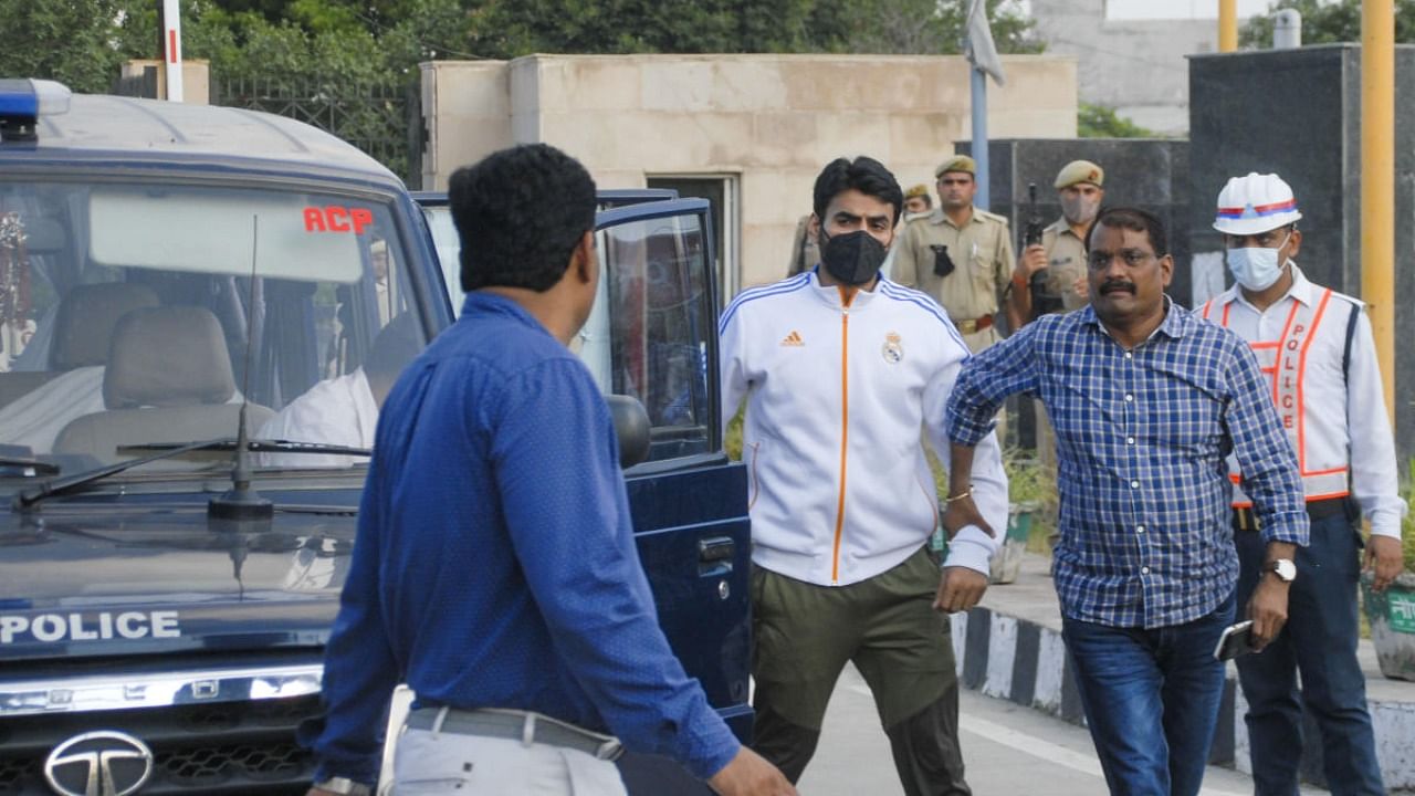 Shrikant Tyagi, accused of assaulting a woman, being brought to the Police Commissioner's office after he was arrested by UP Police, in Noida, Tuesday, Aug. 9, 2022. Credit: PTI Photo