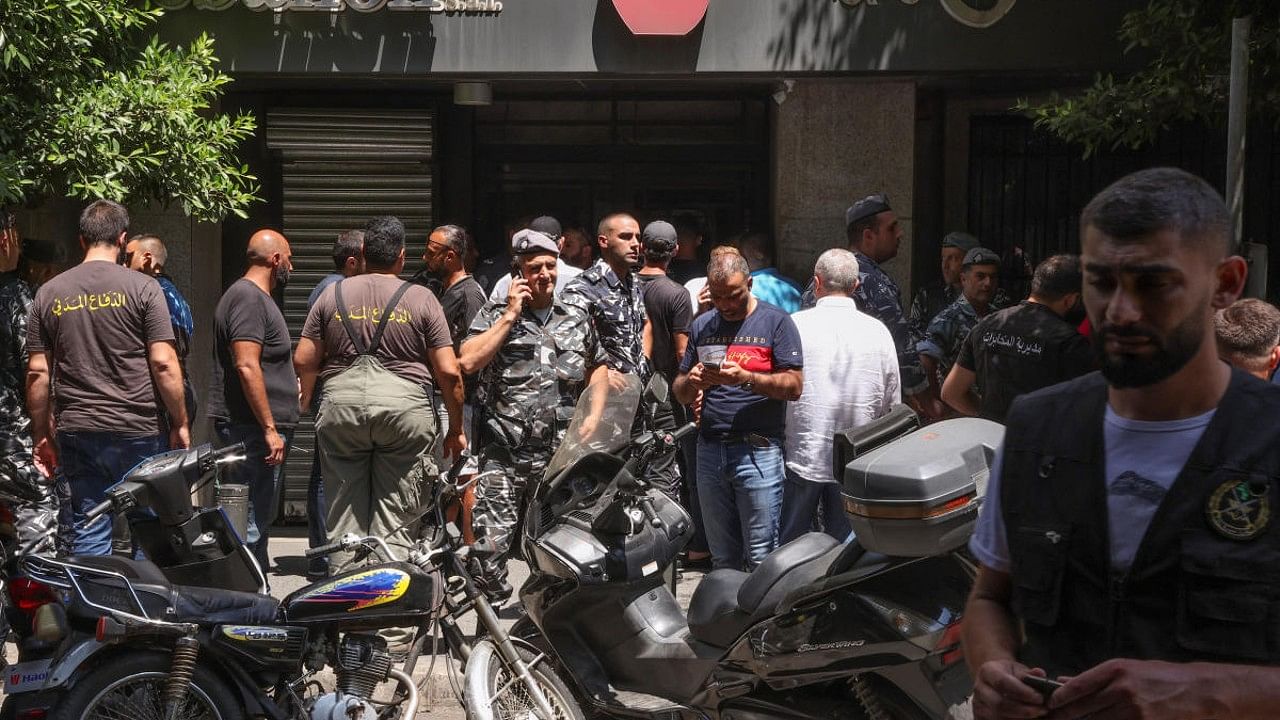 Members of Lebanese police and civil defence secure the area outside Federal bank in Hamra. Credit: Reuters Photo