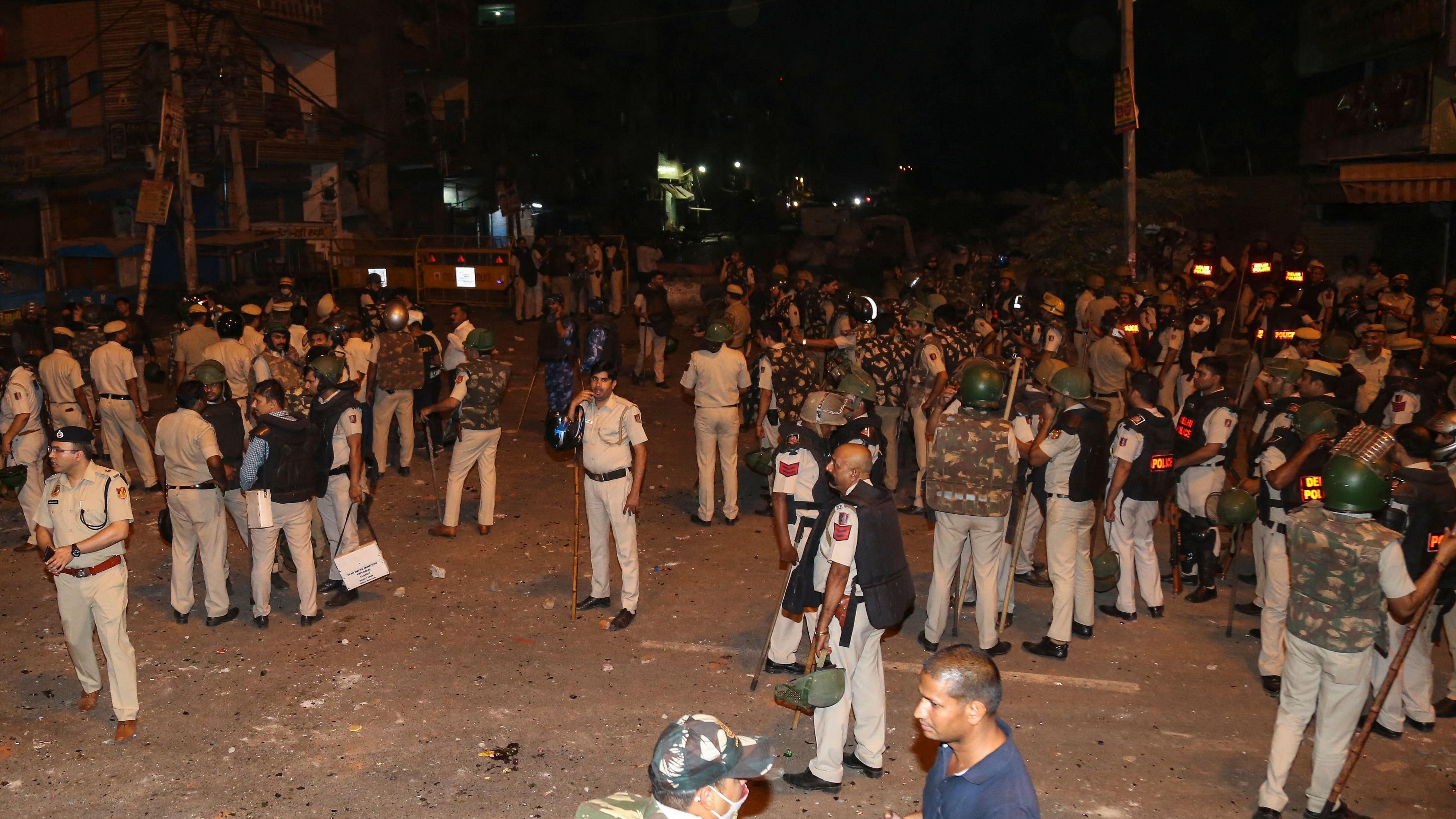 Police personnel stand guard in a residential area of Jahangirpuri, in New Delhi on April 16, 2022. Credit: AFP Photo