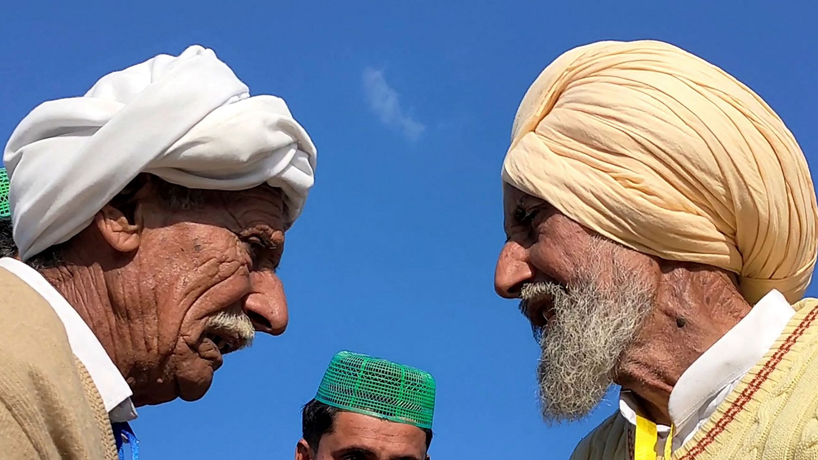  Indian Sikh labourer Sika Khan (R) speaking with his elder brother Sadiq Khan from Pakistan near the India-Pakistan border at the Kartarpur corridor. Credit: AFP Photo/Courtesy of Pakistan's Youtuber Nasir Dhillon