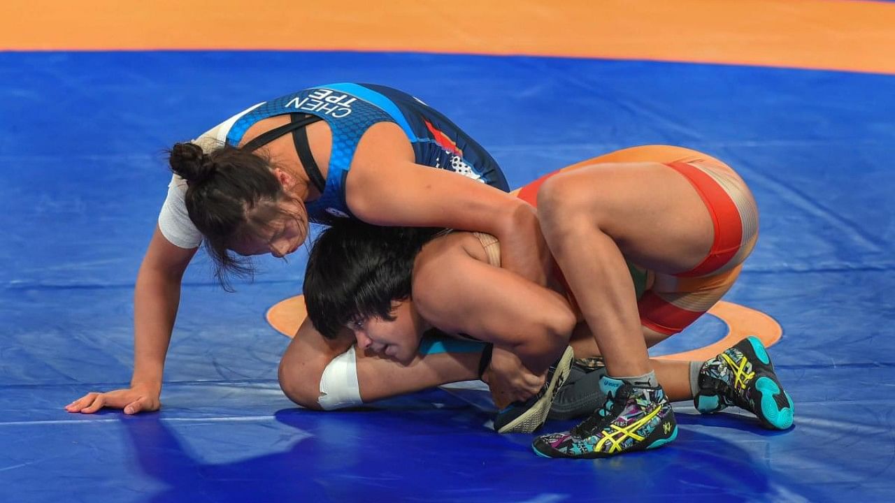 Wrestler Divya Kakran (R) grapples with Chinese Taipei's Chen Wenling. Credit: PTI File Photo