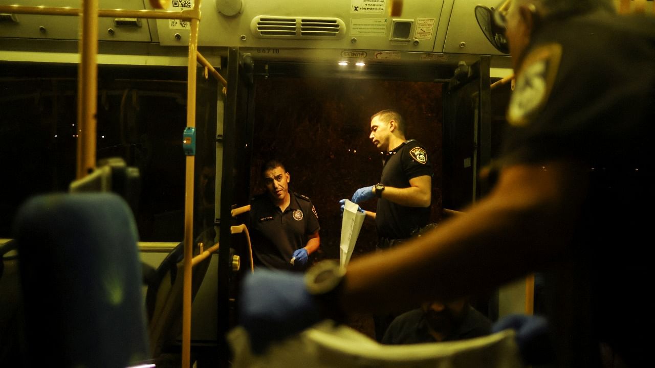 Israeli police officers check a bus following an incident in Jerusalem. Credit: Reuters Photo