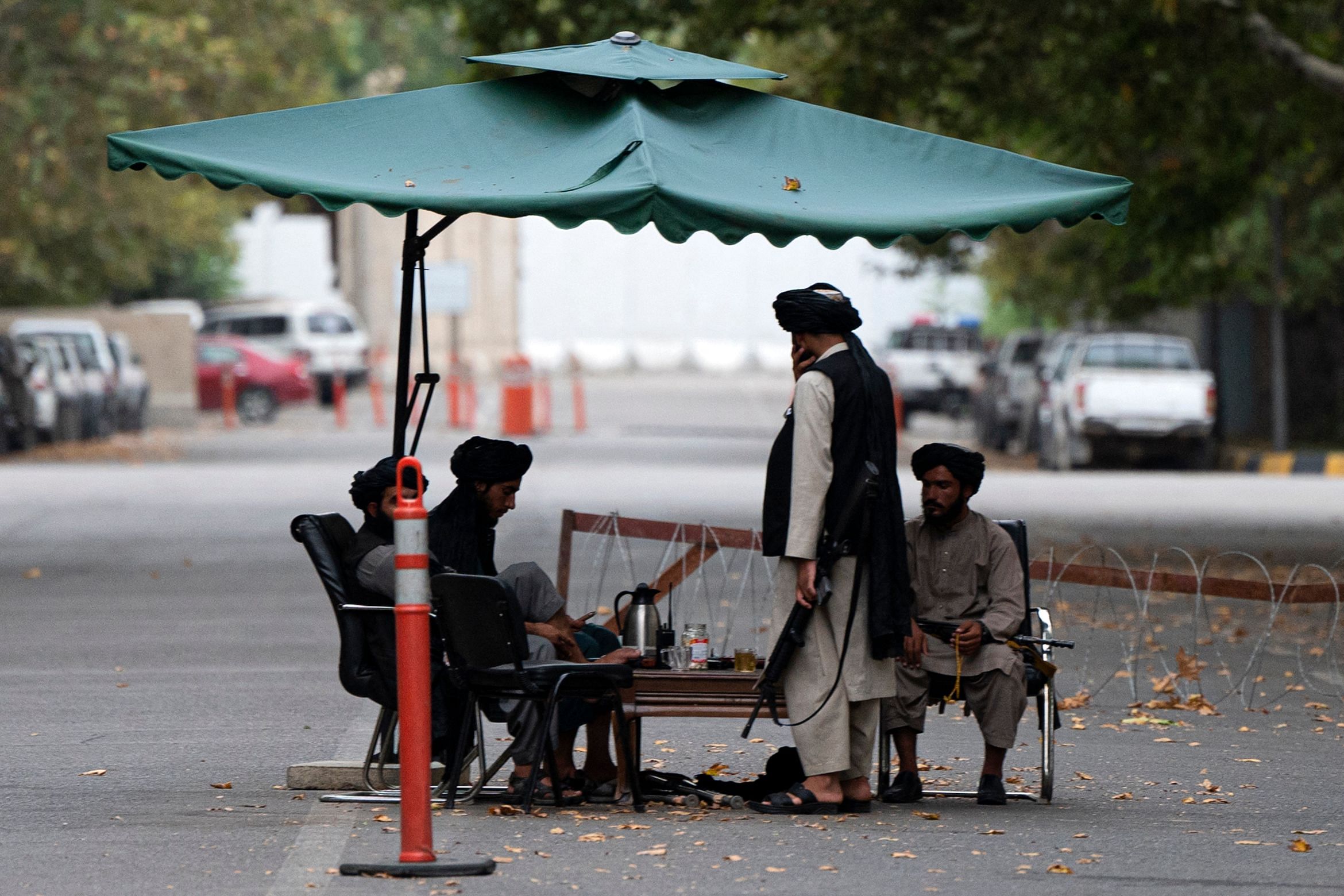 Taliban fighters sit at a guarding post after a gathering attended by Afghanistan's Prime Minister Mohammad Hassan Akhund. Credit: AFP Photo