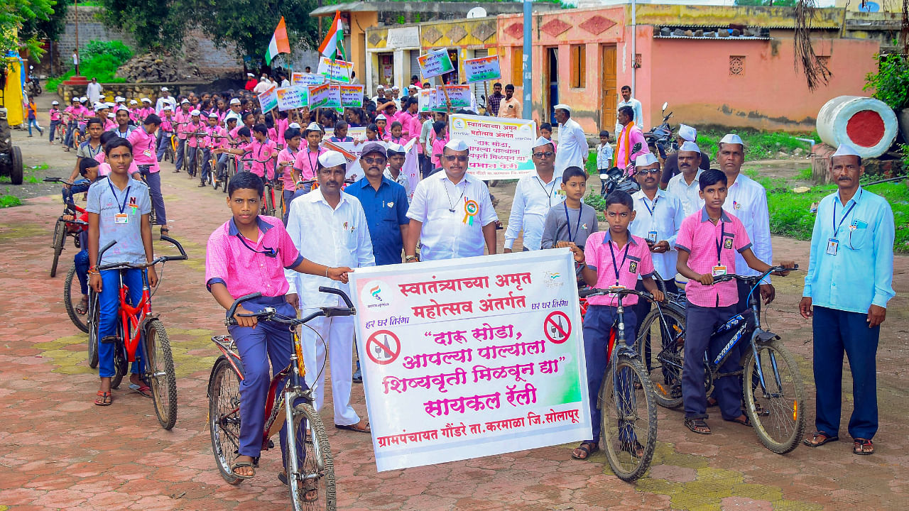 Residents of Gaundare village take out a cycle rally to spread awareness about the scheme - 'Give-up Drinking and Earn Scholarship for Children', in Karmala tehsil of Solapur district. Credit: PTI Photo