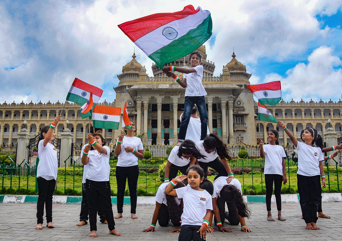 A group of children perform in front of the Vidhana Soudha as part of Azadi Ka Amrit Mahotsav celebrations ahead of Independence Day in Bengaluru. PTI PHOTO