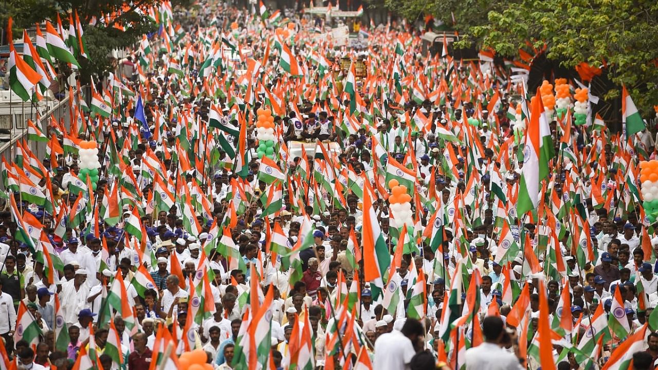 Congress party workers and supporters hold national flags during a "Freedom March" to celebrate the 75 years of India's Independence in Bengaluru. Credit: PTI Photo
