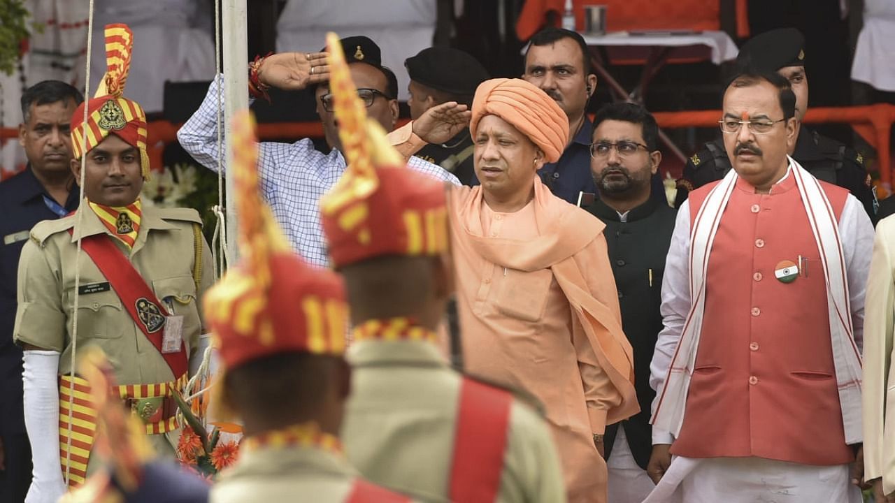 Uttar Pradesh Chief Minister Yogi Adityanath with Deputy CM Keshav Prasad Maurya pays salute to the National Flag. Credit: PTI Photo