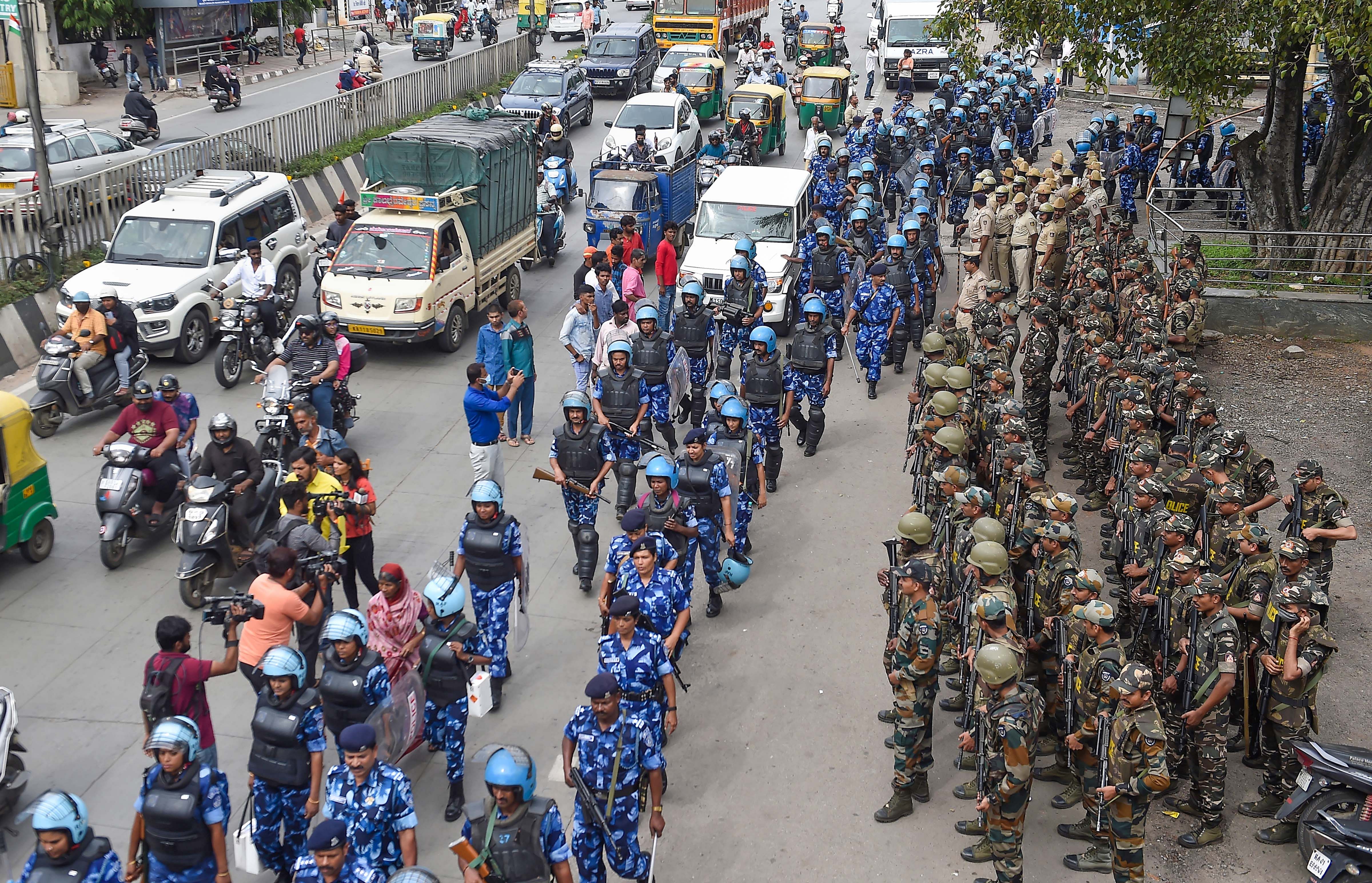 District Special Weapons and Tactics Team (D-SWAT) and Rapid Action Force (RAF) team during a flag march amid controversy over the disputed Idgah Maidan, on the eve of 76th Independence Day. Credit: PTI Photo