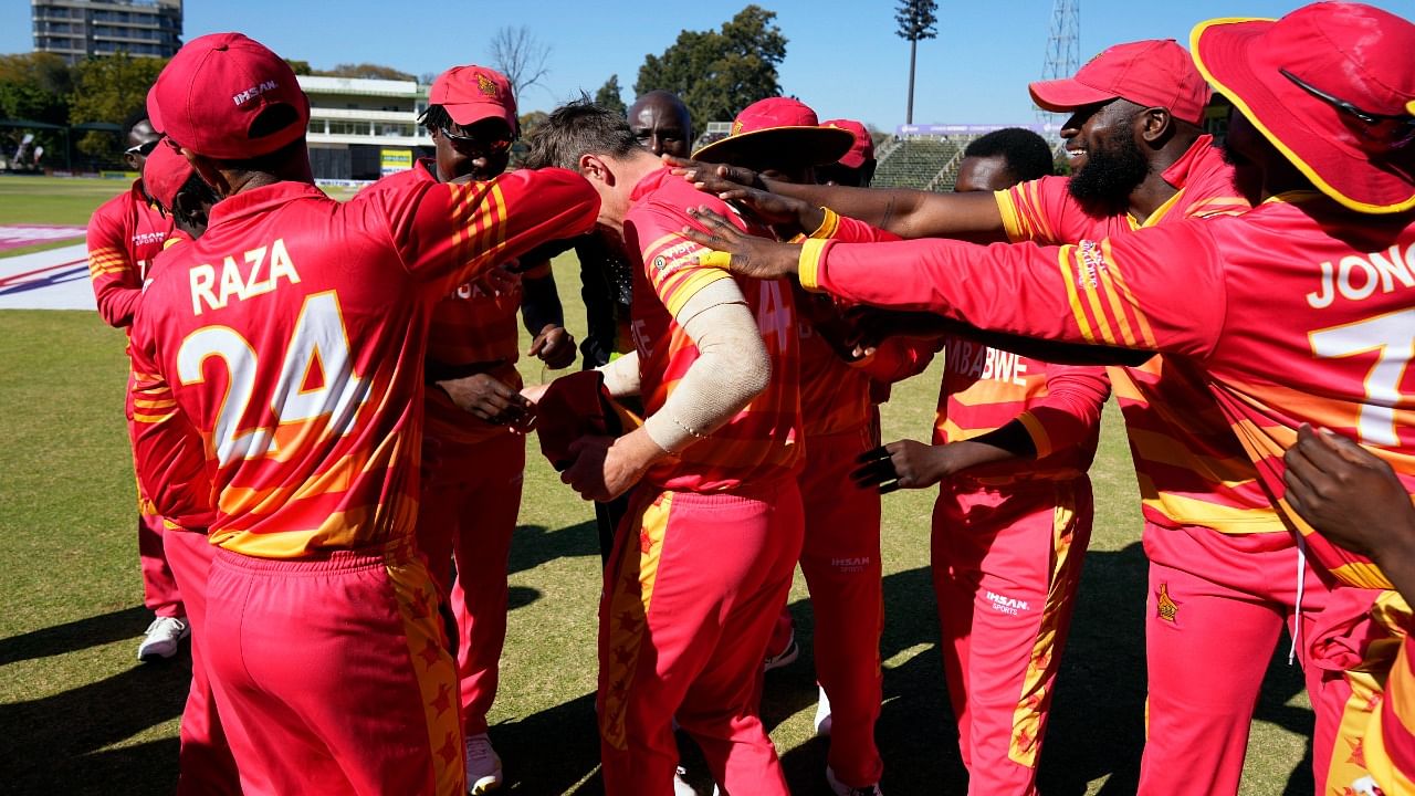 Zimbabwean player Bradley Evans, centre, is given cap on his debut on the second day of the One-Day International. Credit: AP Photo
