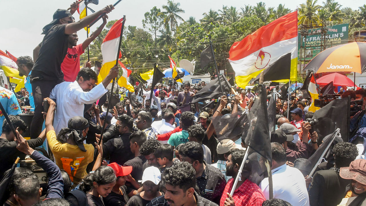 Fishermen and locals holding black flags stage a protest against Adani Groups' port development project at Vizhinjam. Credit: PTI Photo