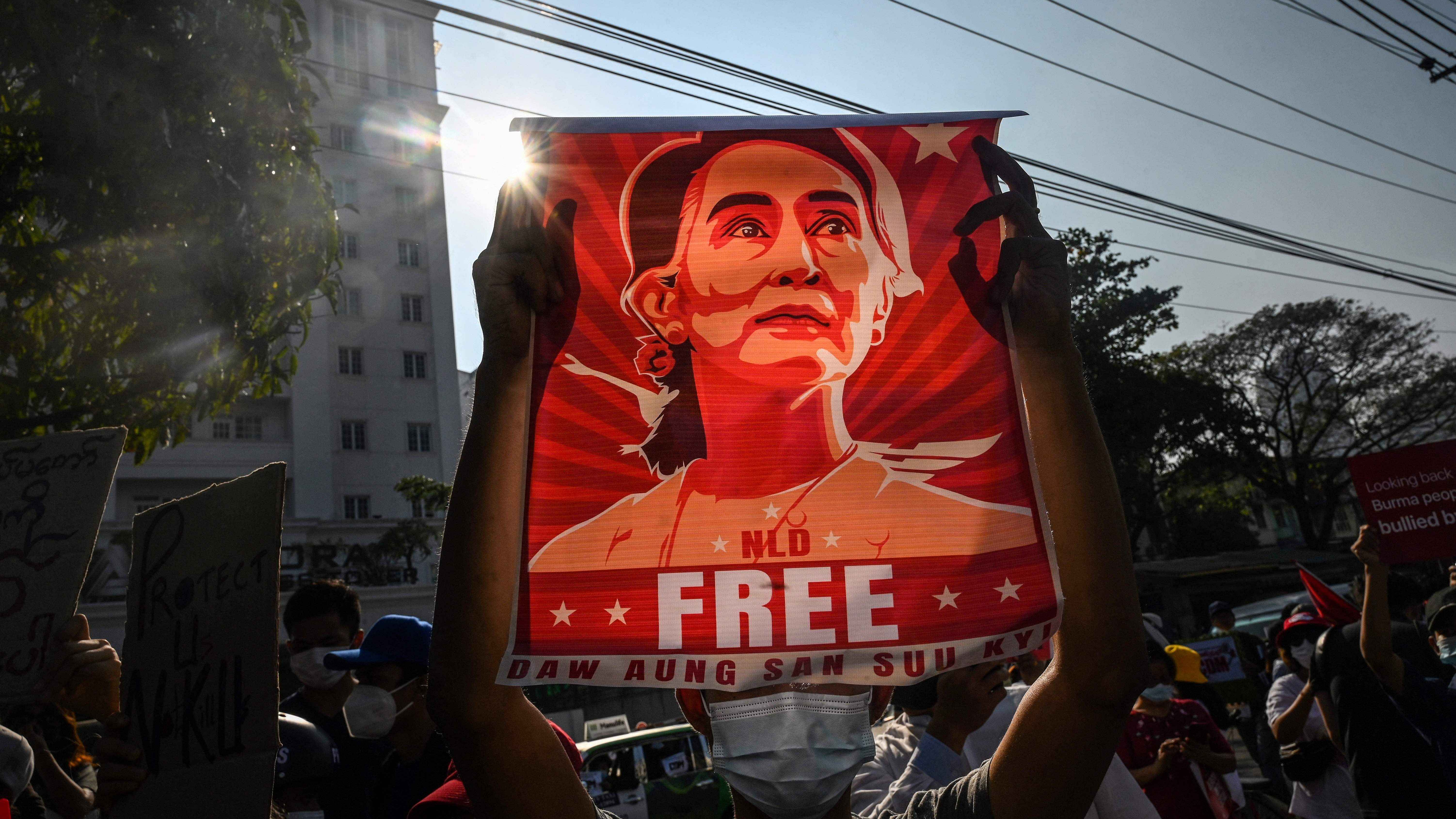 Protester holding up a poster featuring Aung San Suu Kyi during a demonstration against the military coup in front of the Central Bank of Myanmar. Credit: AFP Photo