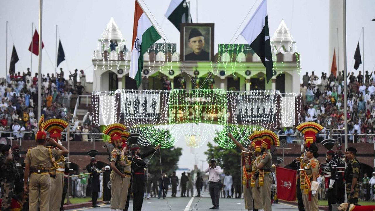  Indian Border Security Force (BSF) soldiers and Pakistani Rangers (in black) taking part in the Beating the Retreat ceremony during India's 75th Independence Day celebrations at the India-Pakistan Wagah border post. Credit: AFP Photo