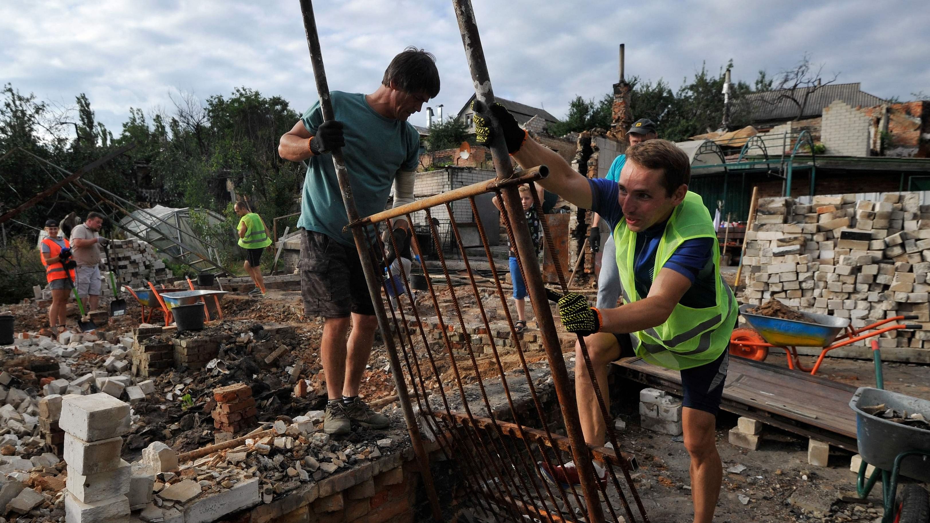 Volunteers clear the rubble of a house destroyed as a result of the shelling in the city of Chernihiv on August 19, 2022, amid Russia's invasion of Ukraine. Credit: AFP Photo