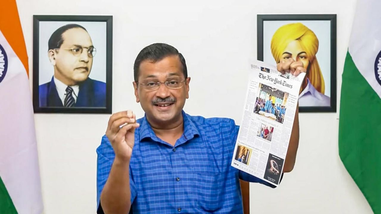 Delhi CM Arvind Kejriwal shows report about Delhi's education system from The New York Times, in New Delhi. Credit: PTI Photo