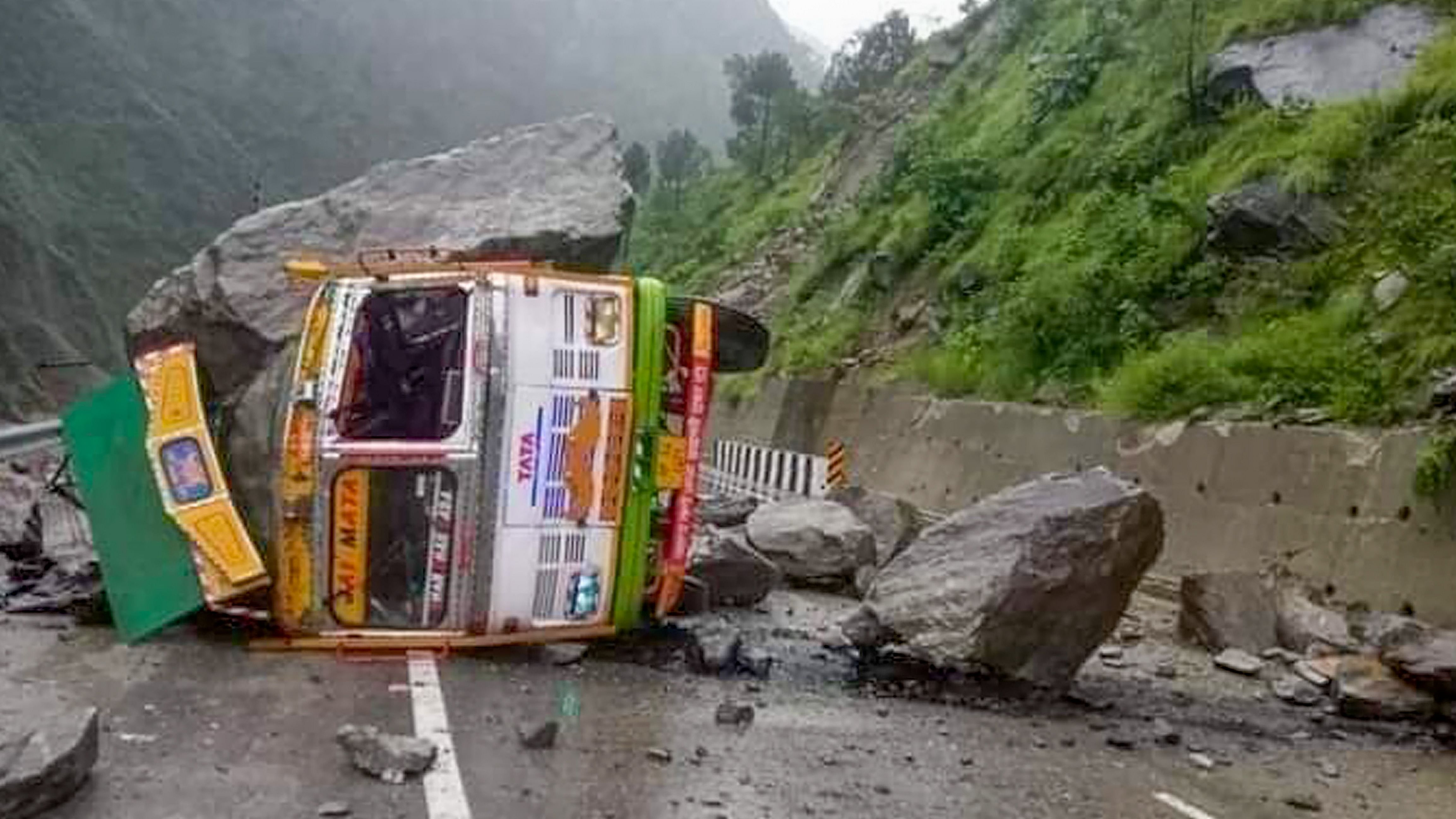 A truck damaged by boulders after landslide triggered by heavy monsoon rains, near Mandi. Credit: PTI Photo