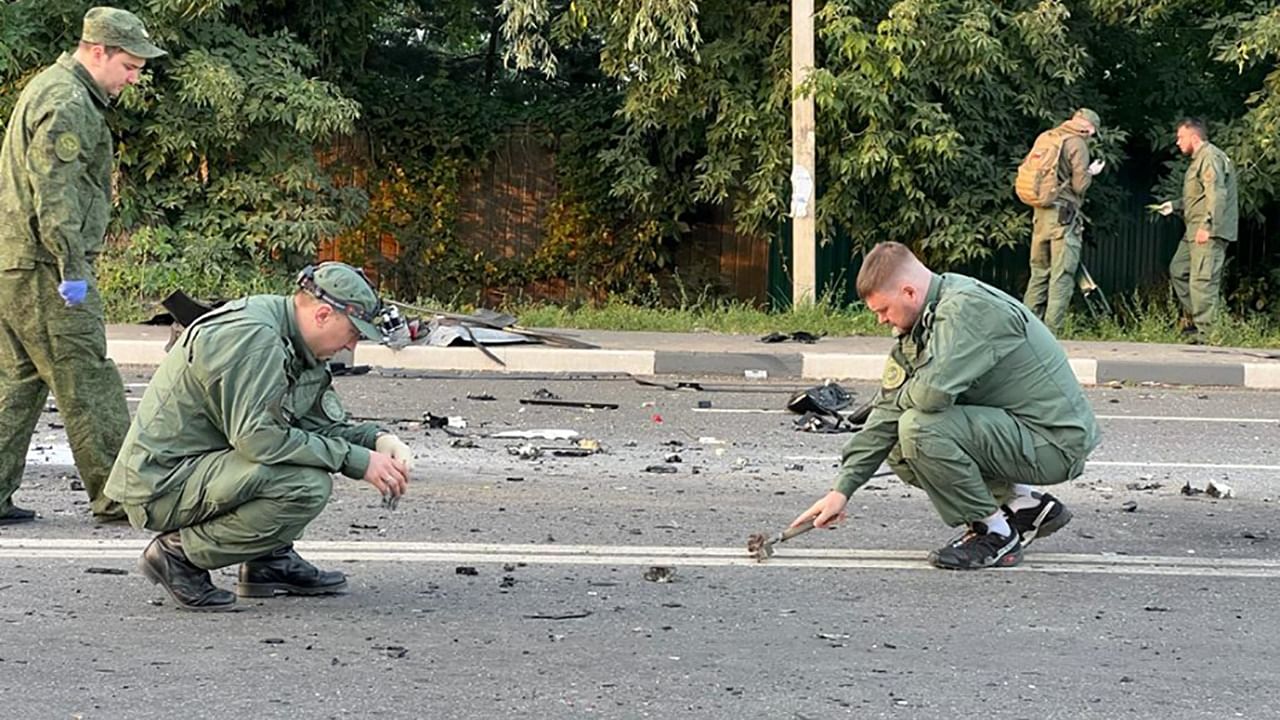 This handout picture released by the Russian Investigative Committee on August 21, 2022 shows investigators work on the place of explosion of a car driven by Daria Dugina, daughter of Alexader Dugin. Credit:  AFP Photo