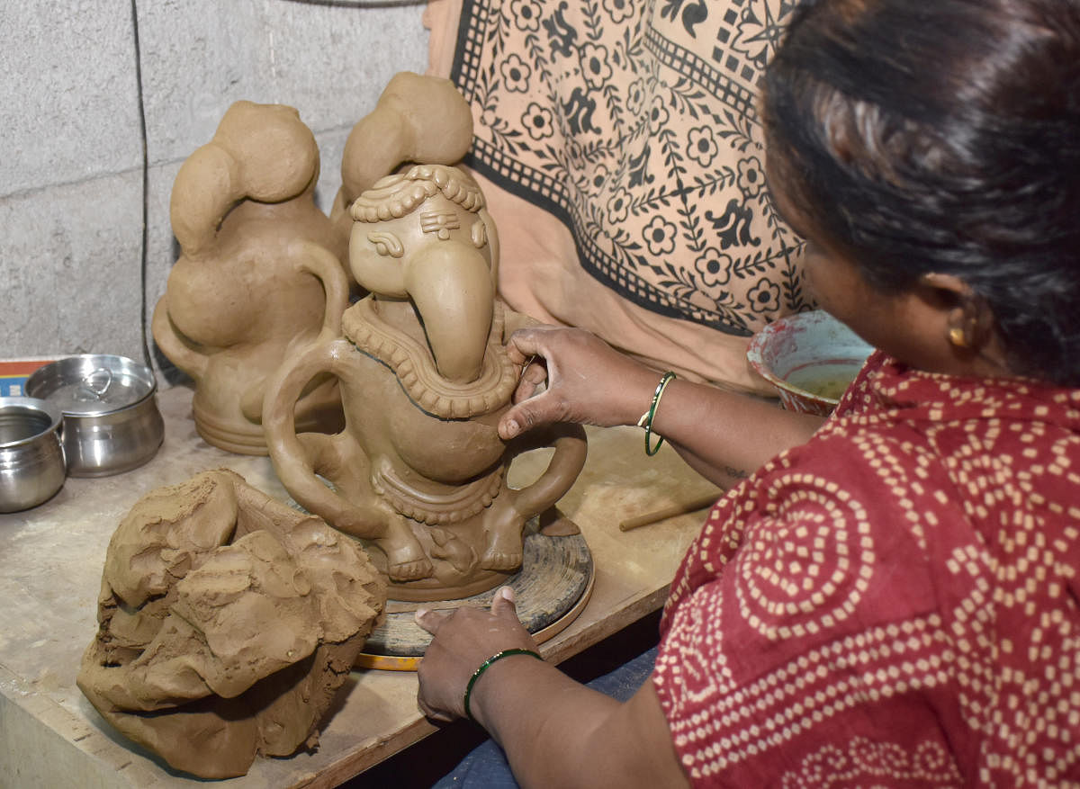 An artisan puts finishing touches to idols at Pottery Town ahead of Ganesh Chaturthi, which will be celebrated on August 31. Credit: DH Photo/B K Janardhan
