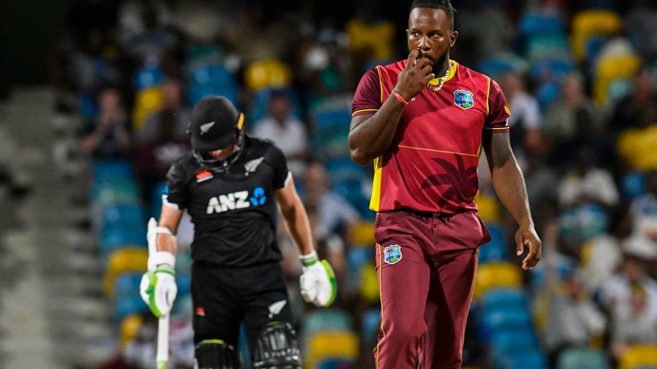 Kyle Mayers (R) of West Indies scratch his cheek after Tom Latham (L) of New Zealand hits 4 during the 3rd and final ODI match. Credit: AFP Photo