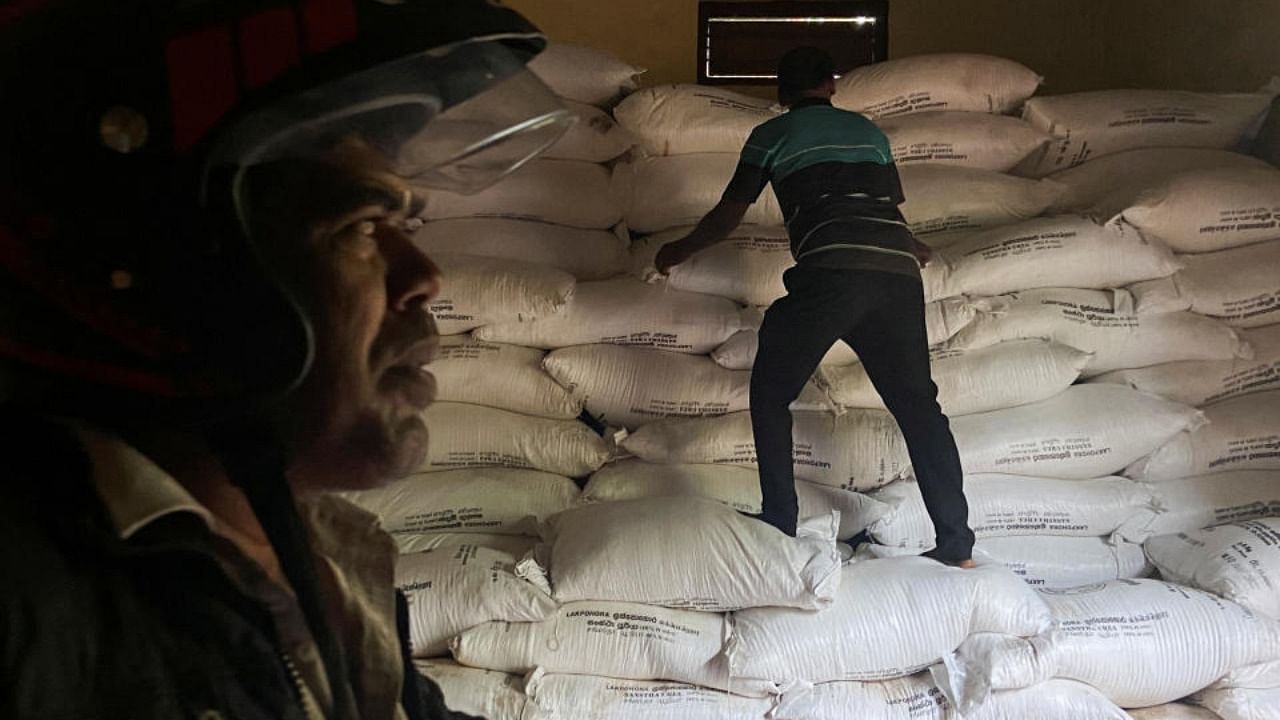 A worker moves bags of urea fertiliser supplied through a credit line from India inside a warehouse, amid the country's worst economic crisis, in Kilinochchi district, Sri Lanka July 29, 2022. Credit: Reuters Photo