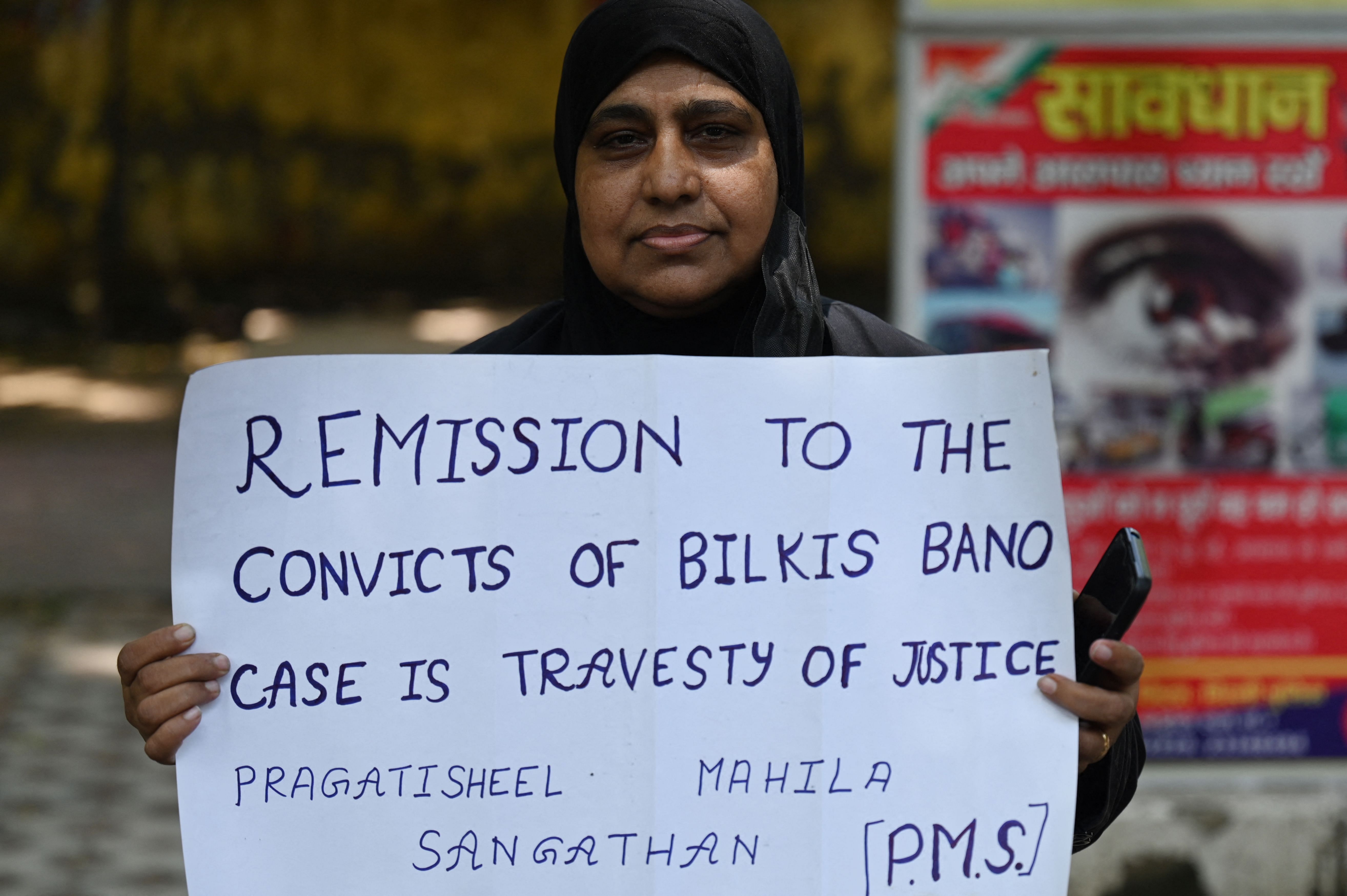 An activist holds a placard during a protest against the release, following a recommendation by a Gujarat's state government panel, of men convicted of gang-raping Bilkis Bano during the 2002 communal riots in Gujarat, in New Delhi. Credit: AFP Photo