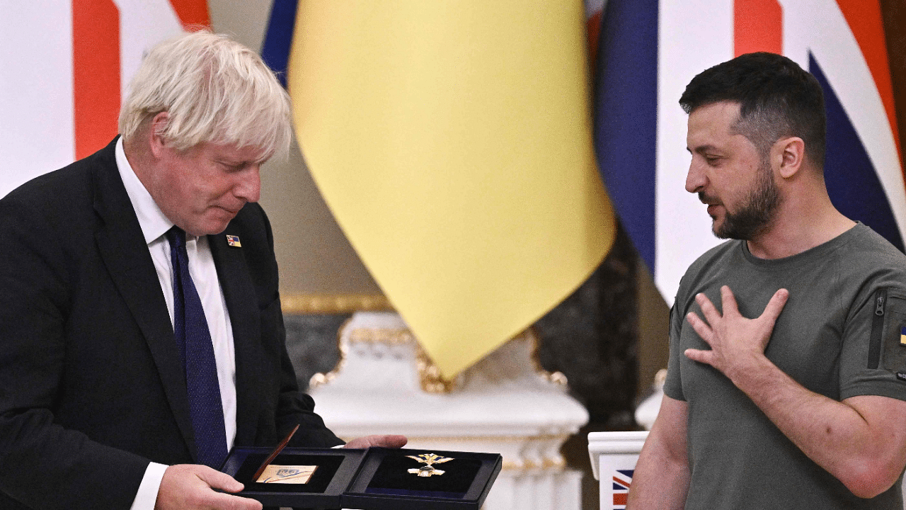 Ukrainian President Volodymyr Zelenskyy (R) hands "The Order of Liberty" medal to British Prime Minister Boris Johnson. Credit: AFP Photo