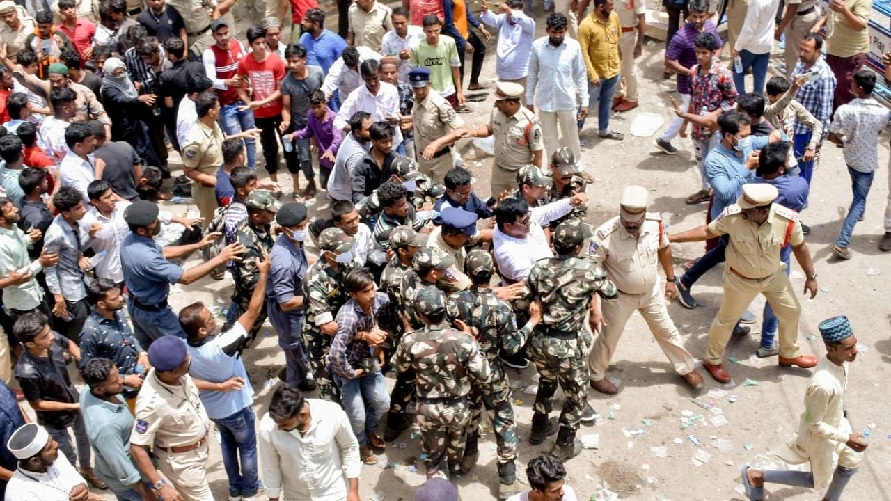 Police personnel attempt to maintain law and order during a protest against Telangana's BJP MLA T Raja Singh for his controversial remarks. Credit: PTI Photo