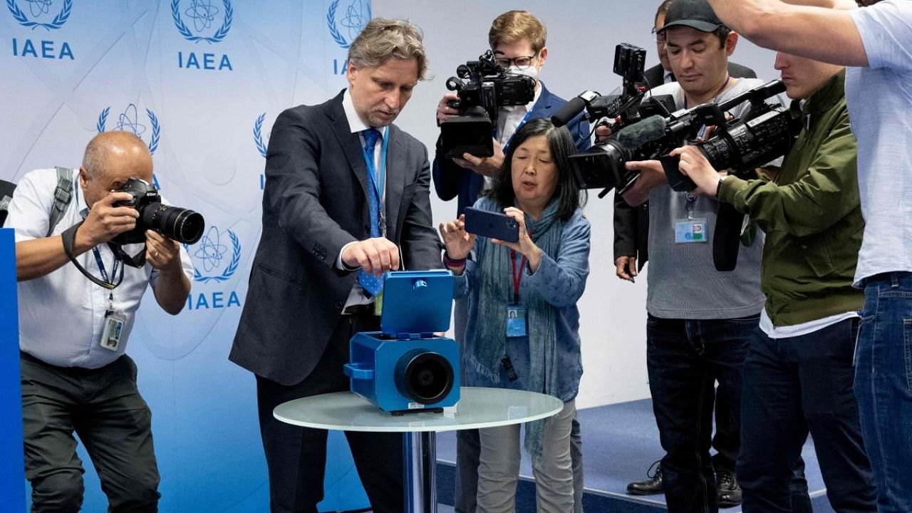 Photographers and cameramen watch a demonstration of a monitoring camera used in Iran during a press conference of Rafael Grossi, Director General of the International Atomic Energy Agency (IAEA). Credit: AFP Photo