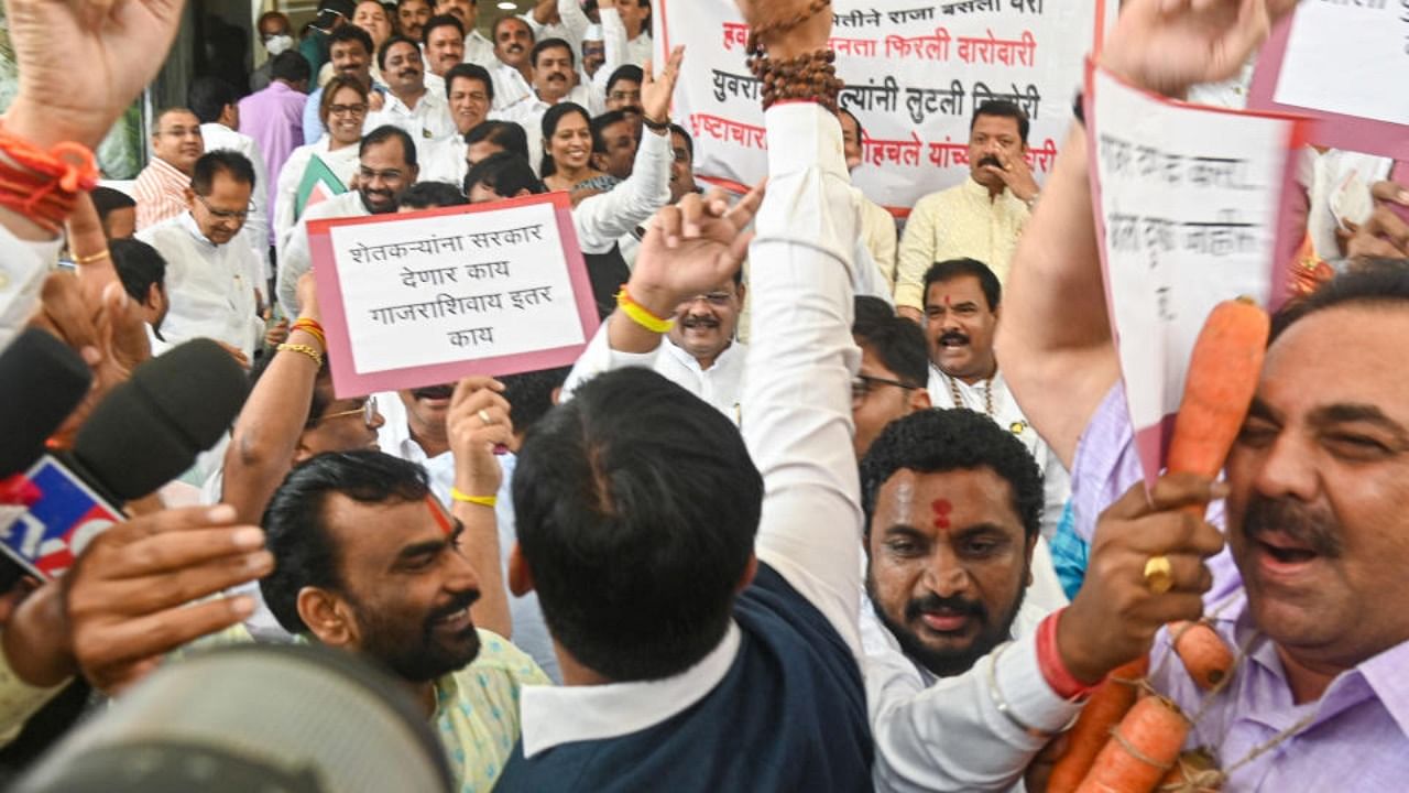  Opposition and rebel Shiv Sena MLAs raise slogans against each other outside the Maharashtra Assembly during its ongoing Monsoon session, in Mumbai, Wednesday, Aug. 24, 2022. Credit: PTI Photo
