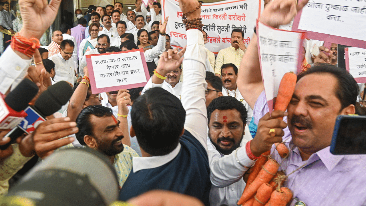 Opposition and rebel Shiv Sena MLAs raise slogans against each other outside the Maharashtra Assembly during its ongoing Monsoon session. Credit: PTI Photo