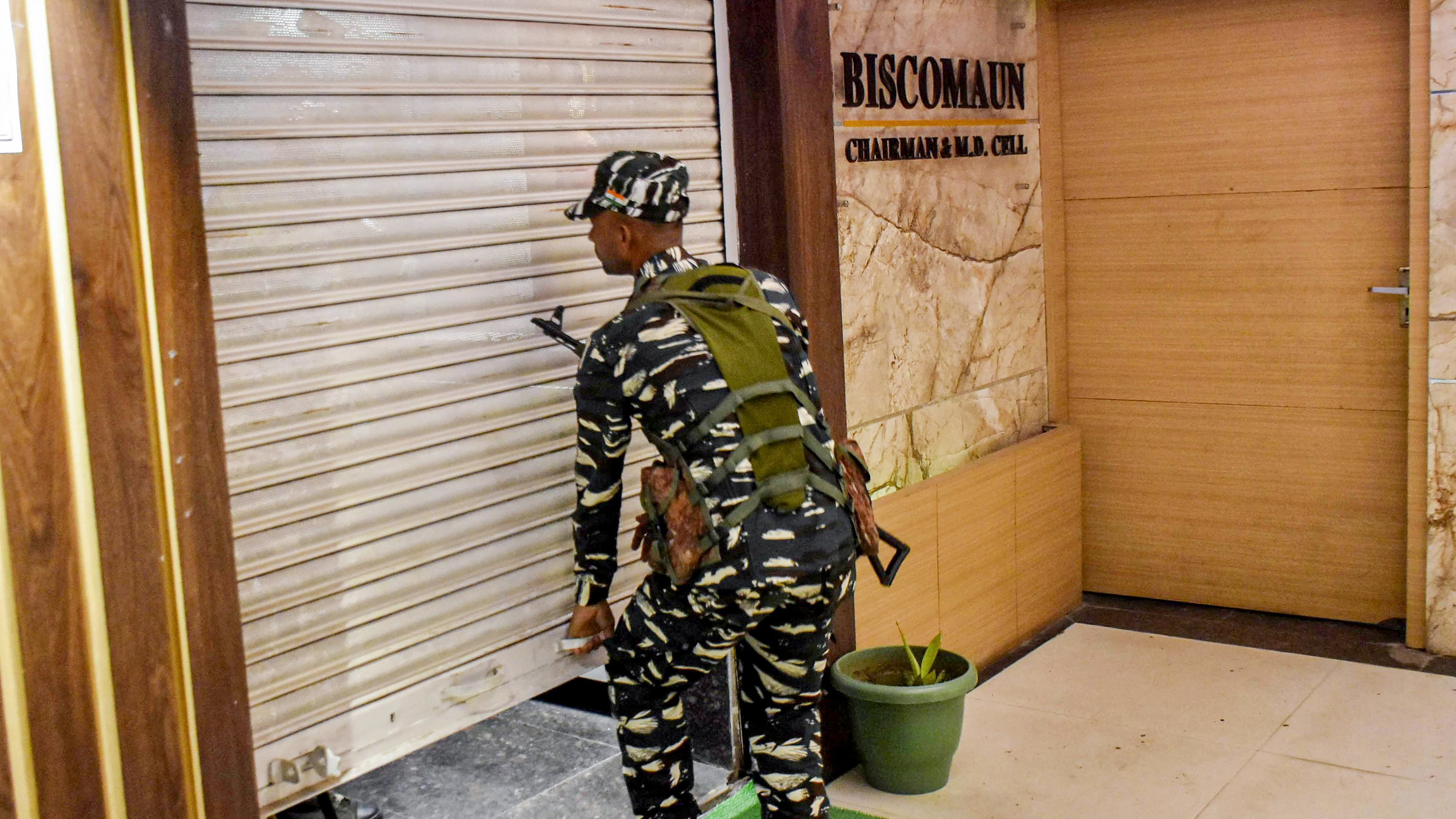 A security personnel outside an office of RJD MLC Sunil Kumar after a raid by Central Bureau of Investigation (CBI) in connection with the alleged land-for-jobs scam that took place when Lalu Prasad was the railway minister, in Patna. Credit: PTI Photo