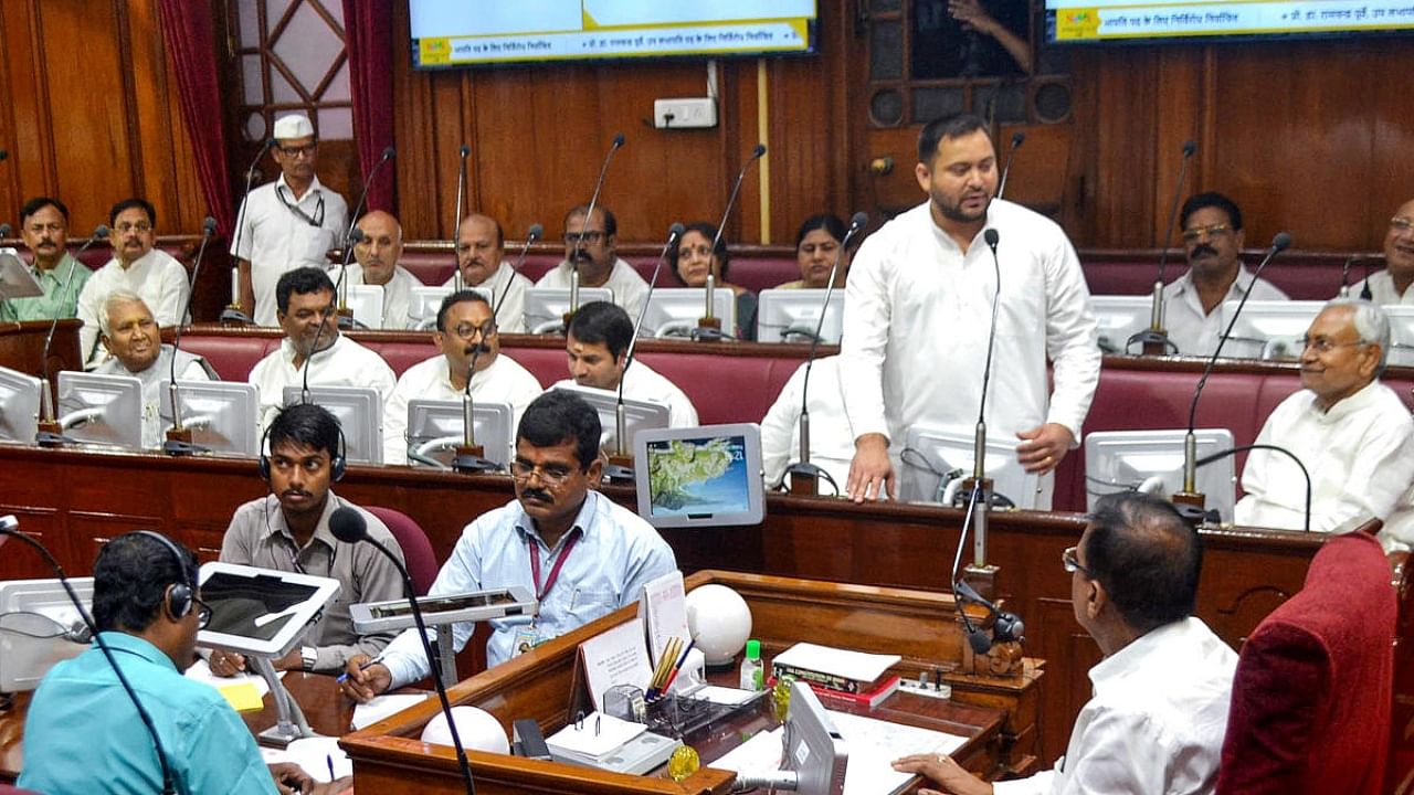 Bihar Deputy Chief Minister Tejashwi Yadav speaks as Chief Minister Nitish Kumar and others look on during a special session of Bihar Vidhan Parishad, in Patna. Credit: PTI Photo