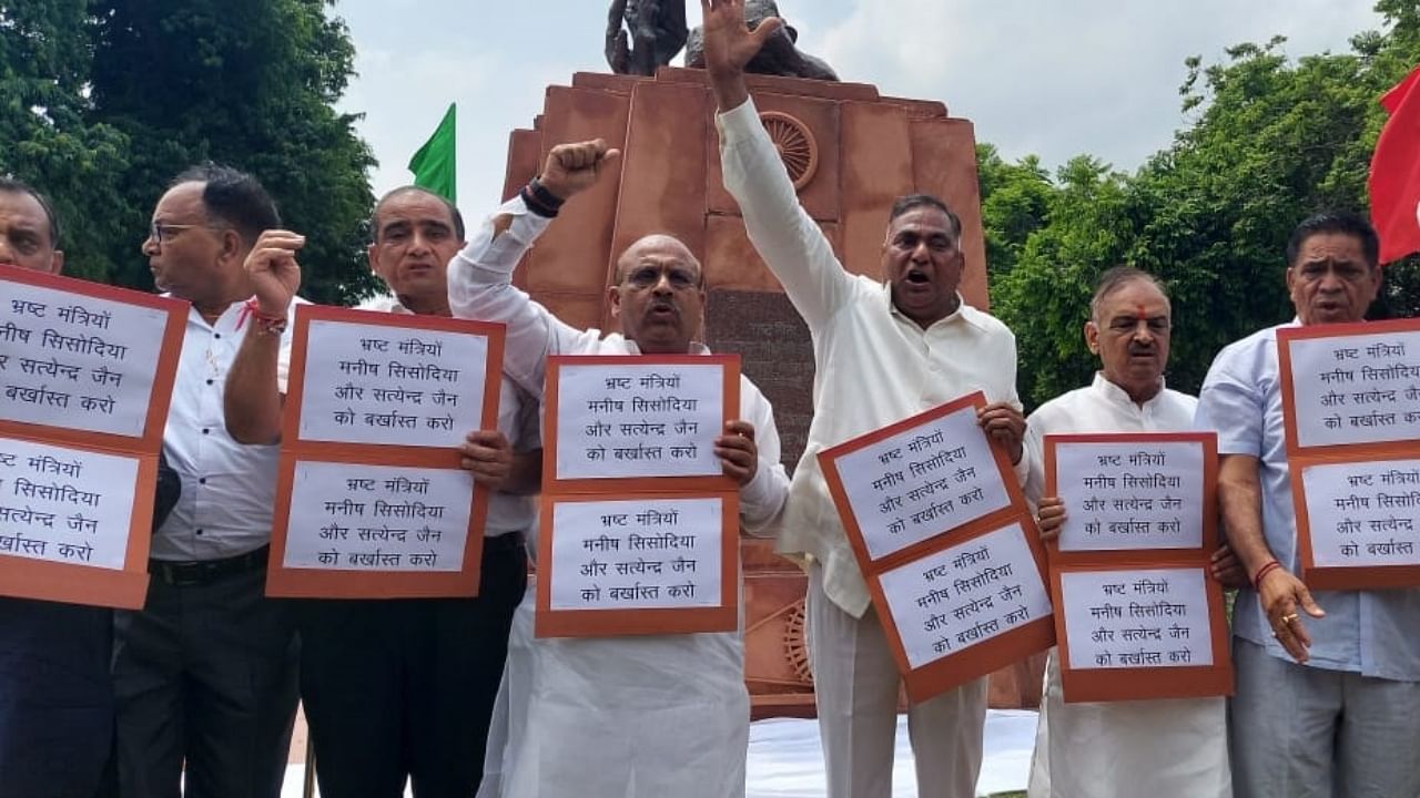 BJP MLAs protest outside the House after being marshalled out. Credit: Twitter/@ANI