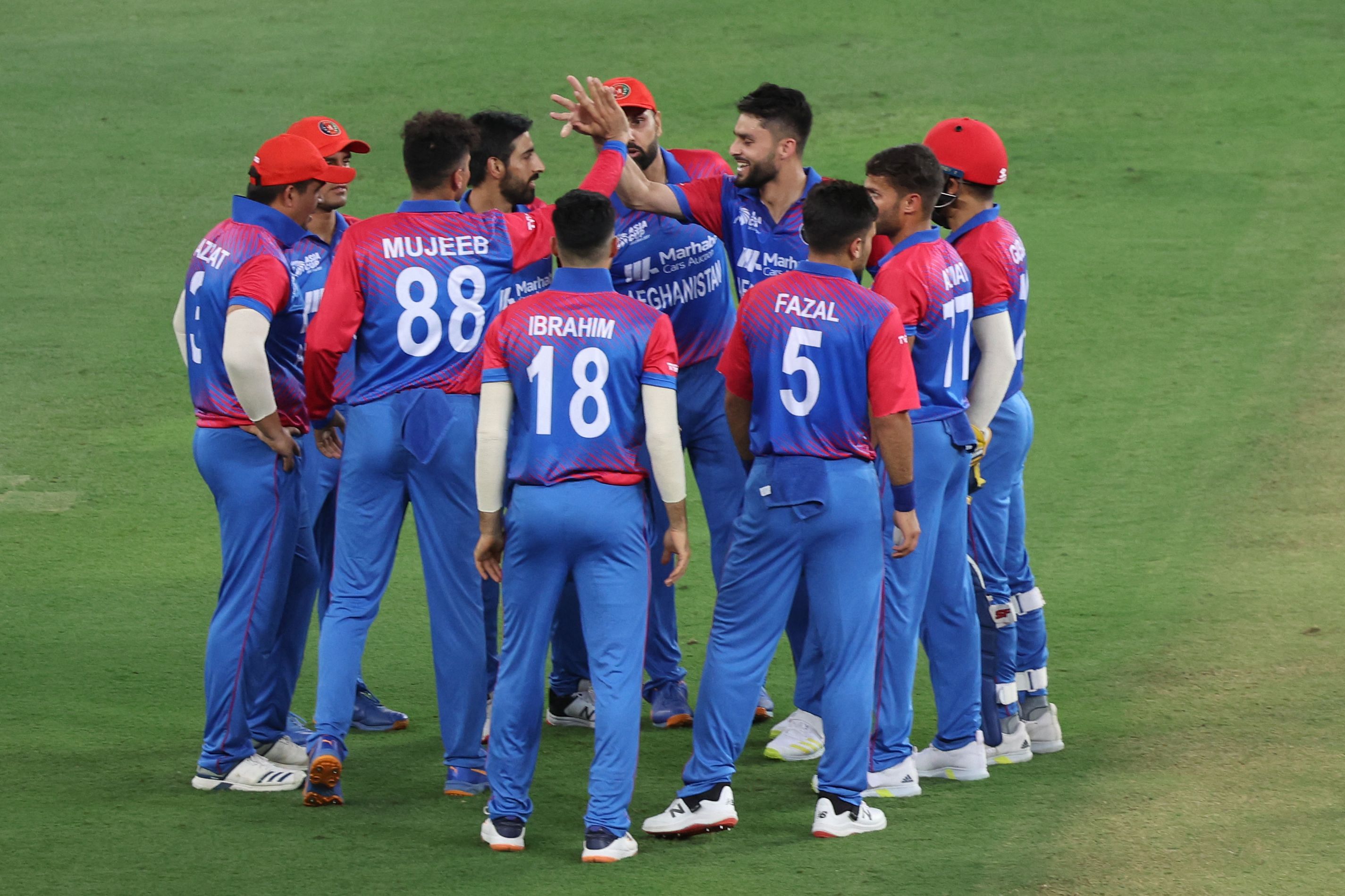 Afghanistan's Mujeeb Ur Rahman celebrates with teammates after dismissing Sri Lanka's Danushka Gunathilaka (not pictured) during the Asia Cup Twenty20 International cricket Group B match between Sri Lanka and Afghanistan at the Dubai International Cricket Stadium. Credit: AFP Photo