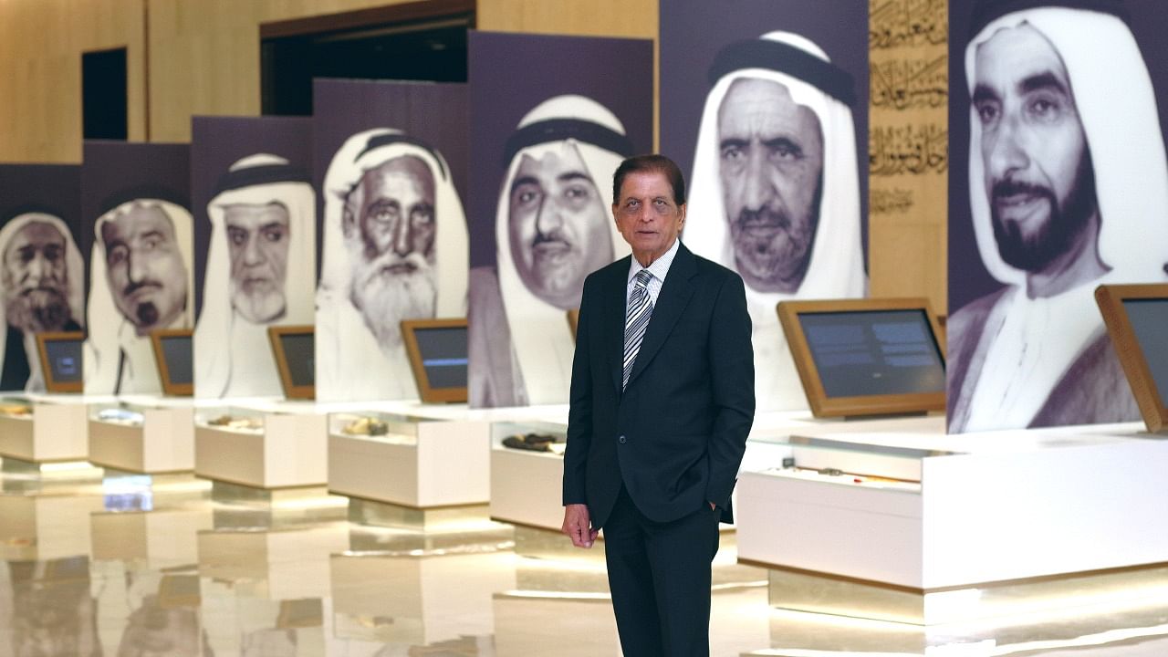 Ramesh Shukla against his series of photographs of the founding fathers of the UAE at the Etihad Museum, Dubai. Credit: Ramesh Shukla 