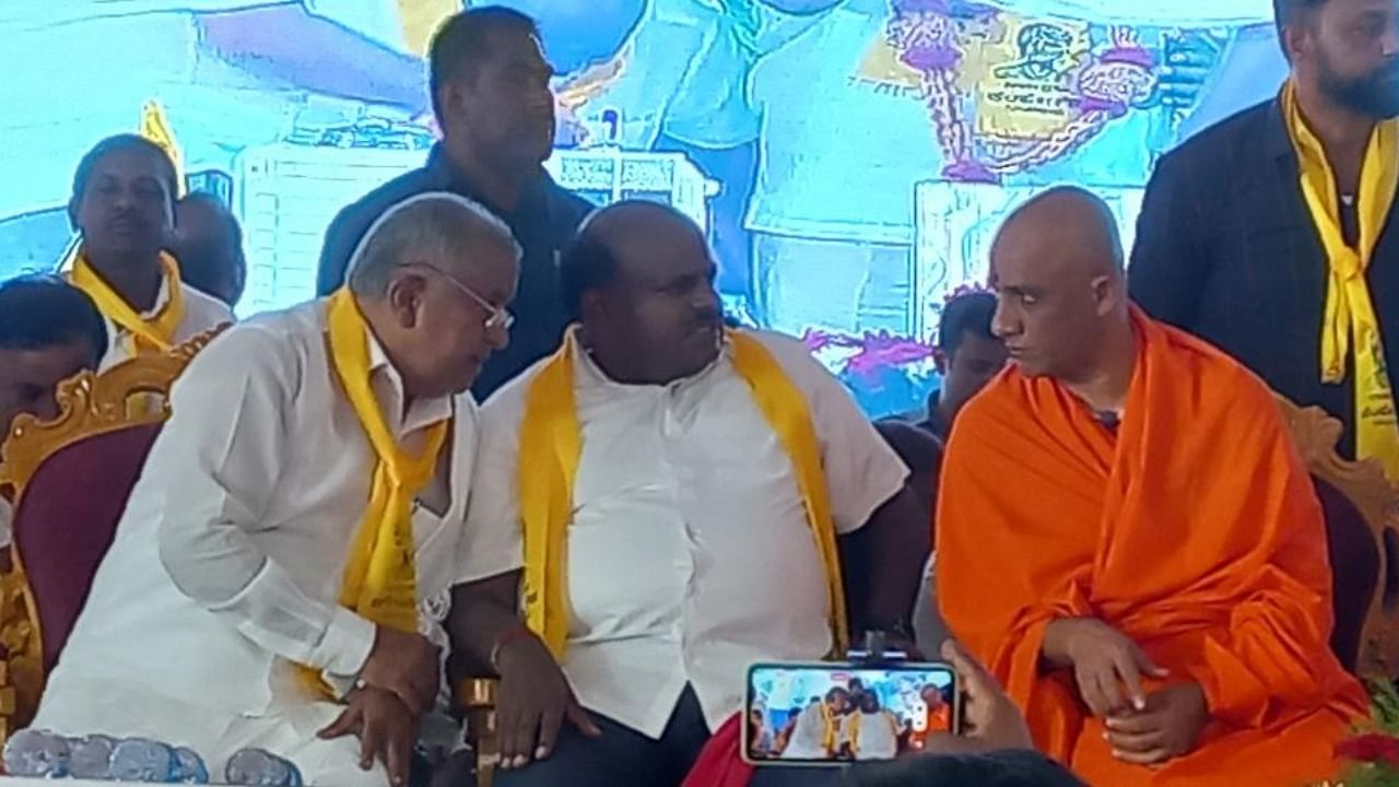 JD(S) leaders G T Devegowda and H D Kumaraswamy seen with Adichunchanagiri seer Nirmalanandanatha Swami during Kempegowda Jayanti in Hunsur on Friday. Credit: DH Photo