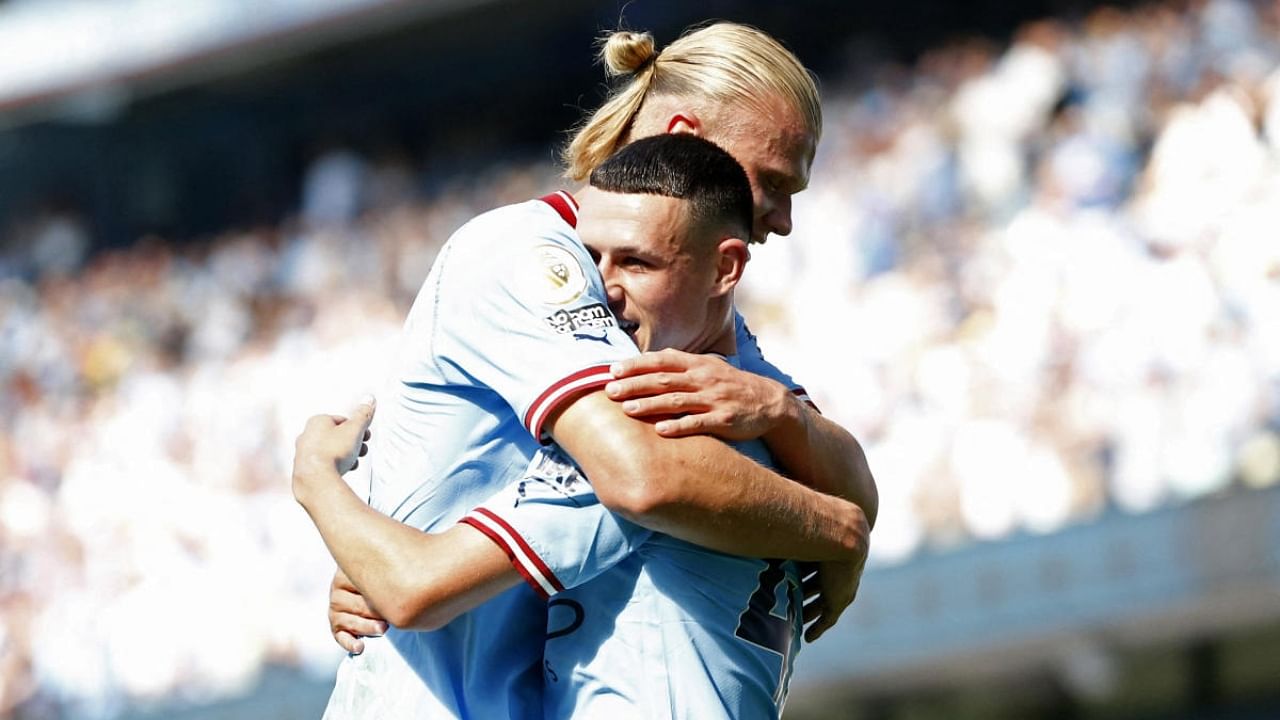 Manchester City's Erling Haaland (L) and Phil Foden. Credit: Reuters Photo