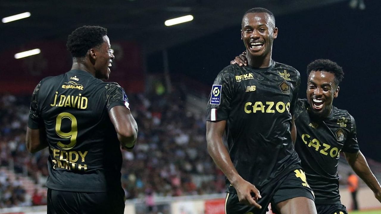 Lille's defender Tiago Emmanuel Embalo Djalo (C) is congratulated by teammates after scoring a third goal for his team during the French L1 football match between AC Ajaccio and Lille at Stade Francois Coty in Ajaccio on the French Mediterranean Island of Corsica. Credit: AFP Photo