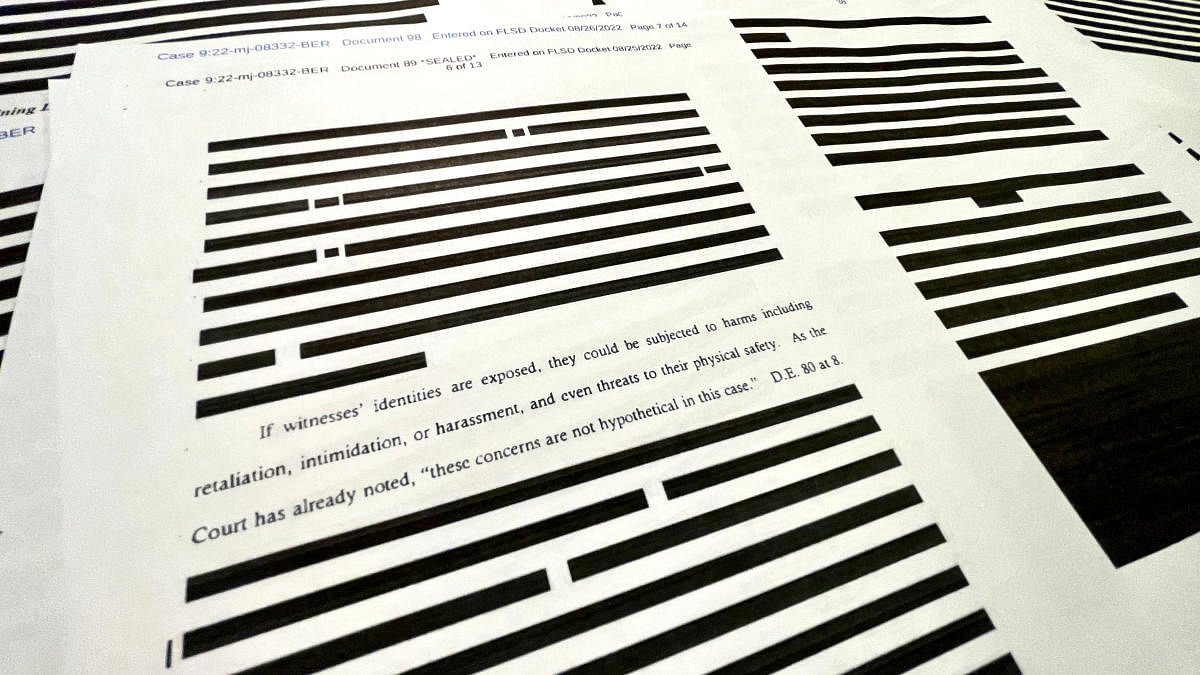 An assertion about potential threats and dangers to witnesses if information about them was released is seen in the midst of pages of redacted information in the released version of an affidavit from the US Justice Department that was submitted to a federal judge to support the execution of a search warrant by the FBI at former President Donald Trump's Mar-a-Lago estate. Credit: Reuters photo