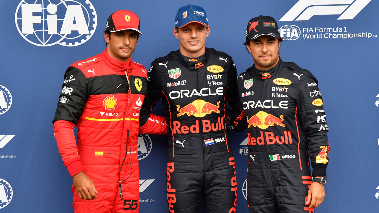 Carlos Sainz Jr, Max Verstappen, and Sergio Perez pose after the qualifying session for the Belgian GP, August 27, 2022. Credit: AFP Photo