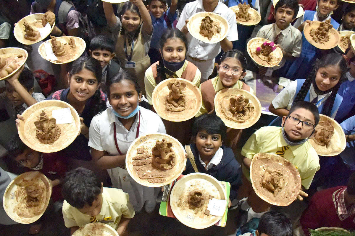 Students with clay Ganeshas prepared during a competition in Malleswaram on Saturday. The event was organised by Malleshwara Youngsters Brigade. DH Photo/B K Janardhan