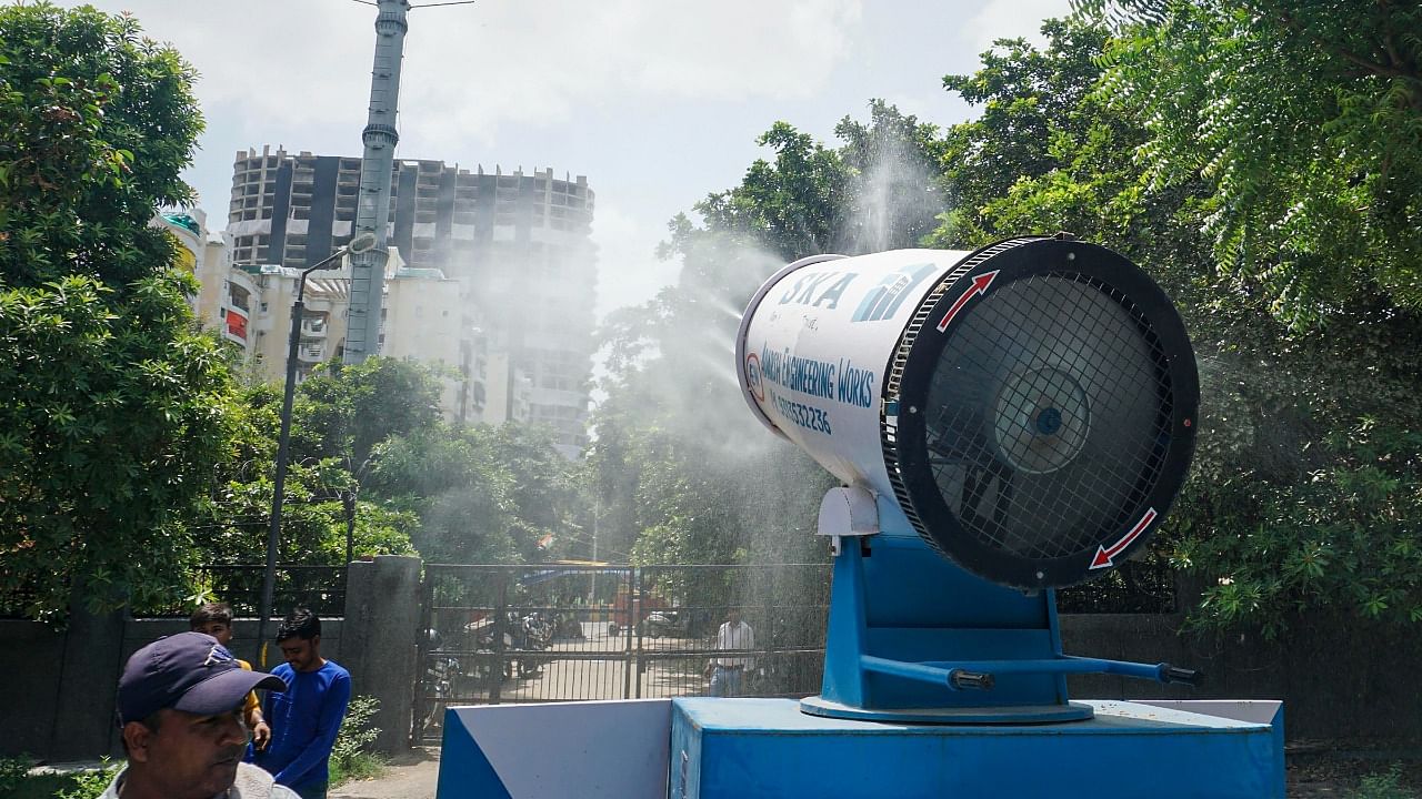 An anti-smog gun is used to curb pollution in the vicinity of Supertech twin towers, ahead of its demolition in Noida. Credit: PTI Photo