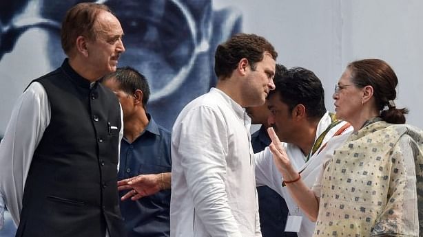 Congress president Sonia Gandhi with Rahul Gandhi and former party leader Ghulam Nabi Azad. PTI file photo