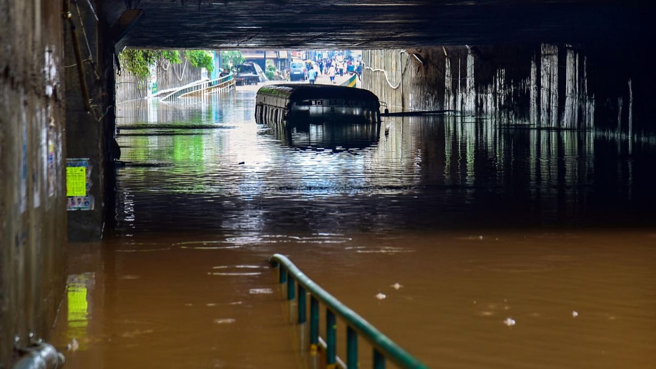 A bus partially submerged at a flooded underpass on the Bengaluru-Mysuru highway following heavy monsoon downpour at Ramanagara. Credit: PTI photo