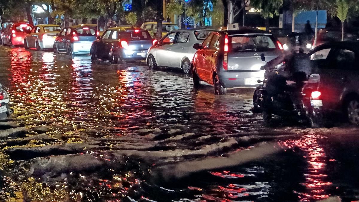 A flooded road in Shanti Nagar. The downpour is leading to power disruptions, sewage line breaches  and road safety problems. DH Photo by S K Dinesh