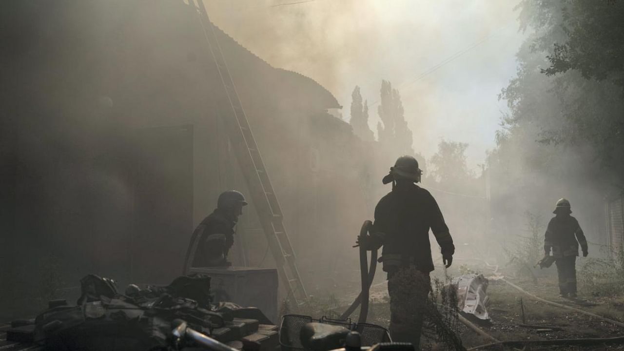 Firefighters work to extinguish a fire after a Russian attack that heavily damaged a building in Sloviansk, Donetsk region, eastern Ukraine. Credit: AP Photo