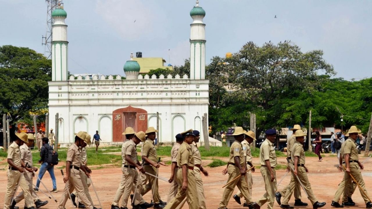  Police personnel deployed at the disputed Idgah Maidan after Karnataka government has permitted the ground to be used for Ganesh Chaturthi celebrations, at Chamarajpet in Bengaluru on Tuesday, Aug 30, 2022. Credit: PTI Photo