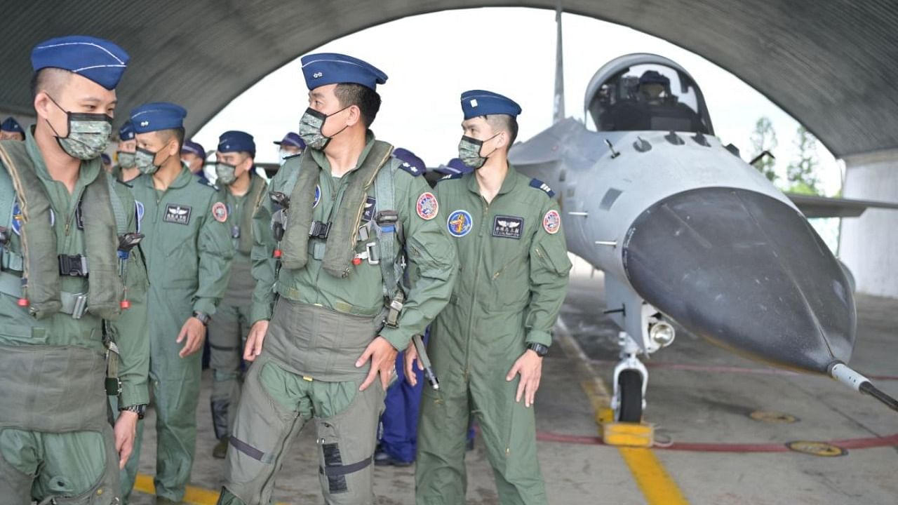 Taiwanese pilots walk pass an Indigenous Defense Fighter (IDF) at an air force base while Taiwan President Tsai Ing-wen (not pictured) inspects military troops on Penghu islands. Credit: AFP Photo