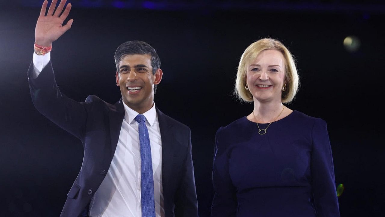 Conservative leadership candidate Rishi Sunak waves as he stands next to co-candidate Liz Truss during a hustings event, part of the Conservative party leadership campaign, in London. Credit: Reuters Photo
