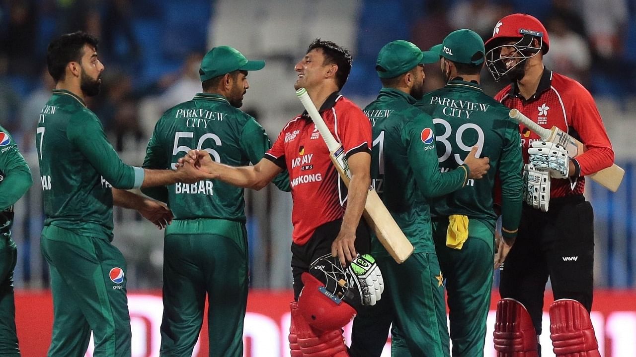  Hong Kong's Ehsan Khan and Mohammad Ghazanfar shake hand with Pakistani players during the T20 cricket match of Asia Cup between Pakistan and Hong Kong. Credit: IANS Photo